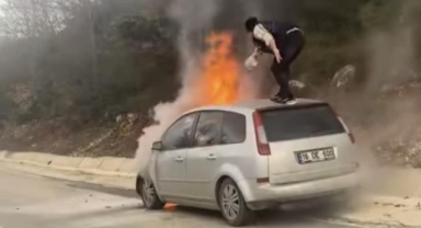 Yanan aracını bir şişe suyla söndürmeye çalıştı