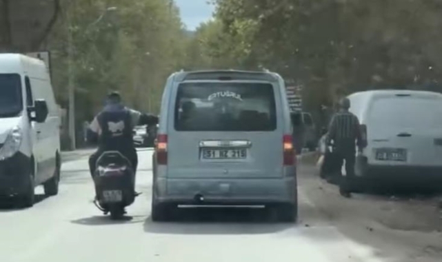 Sohbet etmek için seyir halindeki araca yaslandı